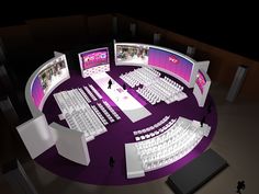 an aerial view of a conference room with multiple screens and people standing around it on the floor