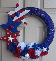 a patriotic wreath with red, white and blue flowers