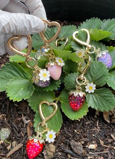 SHIPS TODAY! Adorable iridescent strawberry heart with flower keychains/charms!  Pairs perfectly with keys or on your wallet/purse/backpack/lanyard for that extra bit of cuteness!  Makes a very sweet small (handmade) gift! These charms are approximately 3 inches tall (From top of heart to bottom of strawberry) Color options RED, PURPLE AND LIGHT PINK are not translucent at all, however all other colors are translucent. All color options are iridescent. Car Hanging Accessories, Strawberry Heart, Strawberry Color, Strawberry Hearts, Strawberry Charm, Flower Keychain, Handmade Packaging, Keychain Accessories, Heart Flower