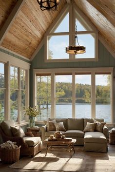 a living room filled with lots of furniture next to a large window covered in wood