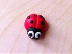 a red ladybug sitting on top of a wooden table