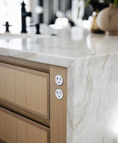 a marble counter top with two buttons on it