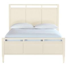 a white bed with two drawers underneath the headboard and pillows on top of it