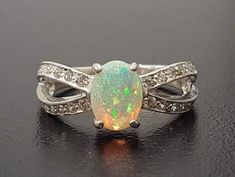 Description: Opal Ring set with a Natural Ethiopian Opal a top grade with naturally flashing colours, 8x6mm, 2 Cts. Engagement Ring design made of Solid 925 Sterling Silver ☞ made to last. Matching Earrings: www.etsy.com/listing/624109925  October Birthstone - Genuine & Natural Stones.  ☞ Choose your size ☞ I resize (before shipping) for FREE to Any size* *Sizes 13-16 U.S. need to be custom made & May include an additional cost, I will contact you before starting to work on those custom-made siz Unique Opal Ring, Opal Ring Vintage, Rings Antique, Unique Opal, Natural Opal Ring, Opal Engagement Ring, Precious Opal, Ring Opal, Fire Opal Ring