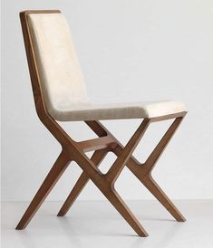 a wooden chair with a white cushion on it