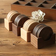 several pieces of wood sitting on top of a wooden table next to a white flower