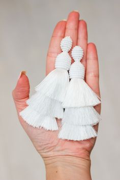 Three Shades of white tassel earrings. Ideal for parties and everyday wear. Silk tassel earrings made of high quality beads and silk threads. If you want to look impressive at the event, birthday party, wedding, so this tassel earrings suitable like no other. This tassel earrings are very ligh. If you wish, i can produce for you this model of earrings in any length or color range. Stud made from silver 925 Length - 11 cm (4.5 inch) Thank you for visiting my shop. Hope you will find something int Silk Earrings, Bridal Accesories, White Tassel Earrings, Cream Earrings, Ivory Earrings, White Tassel, Bead Work Jewelry, Earrings Wedding, Earrings Long