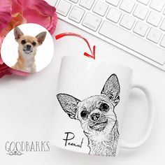 a mug with a dog's face on it next to a keyboard and pink flowers