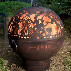 an outdoor fire pit that is made out of wood and has metal designs on it