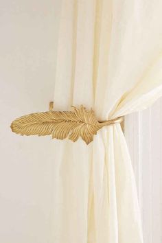 a curtain with a gold leaf attached to it