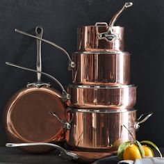 copper pots and pans stacked on top of each other with the words guide to cookware