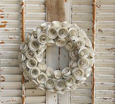 an old door with a wreath made out of rolled up paper