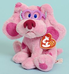 a pink stuffed dog with glasses on it's face and ears, sitting in front of a blue background