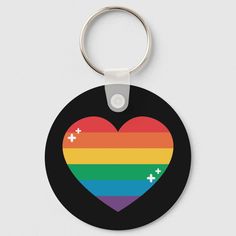 a rainbow heart shaped keychain with crosses on it