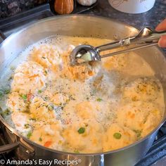 a person is stirring some food in a pot