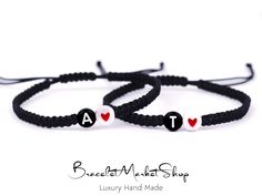 two bracelets with hearts and letters on them