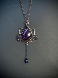 Purple Amethyst Lotus pendant, Wire wrapped copper pendant necklace Material: Copper wire Details:  Pendant length:  2.5 x 2.3 inch Colour: Purple  Amethyst gives a person insight, extinguishes emotional pain, anxiety, fills the aura with good intentions. Purple Amethyst helps to control emotions. During meditation, he initiates the opening of the "third eye". Amethyst is an amulet from drunkenness. Amethyst jewelry is placed under the pillow to see good dreams. Amethyst, according to the sign of the zodiac, is ideally suited to Aquarius, and is also supportive of all the signs of Air. More neklace in my shop you can find here:  https://etsy.me/2Rkuo6O Your necklace will arrive nicely packaged into a beautiful gift box, perfect for gift giving or treating yourself. This design is copyright Wrapped Wire Jewelry, Control Emotions, Wire Wrapped Moon, Wire Wrap Jewelry Designs, Lotus Pendant, Good Intentions, Amulet Necklace, Witchy Jewelry, Stone Wrapping