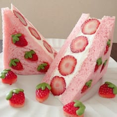 there are strawberries on the cake and one is cut in half