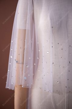 Shiny rhinestones spread on the soft tulle. Take this statement Trendy Shiny Rhinestones Tulle Bridal Cape for Sale to bring some shimmer to your wedding day. Available for wholesale. shown color white sold by the piece content nylon, PET detail rhinestones weight light weight elasticity no length front-45cm, back- 60cm washing instructions hand wash/drip dry * Free size for bust circumference under 125cm. Elegant Sparkling Tulle Fabric For Wedding, Glitter Tulle Fabric With Sequins For Wedding, Embellished Tulle Fabric For Wedding, Wedding Glitter Tulle Fabric, Bridal Cape, Soft Tulle, Drip Dry, Washing Instructions, Free Size