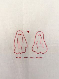 two embroidered ghost faces on a white shirt with red thread in the shape of hearts