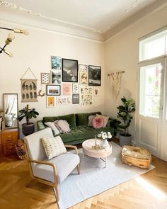 a living room filled with furniture and pictures on the wall