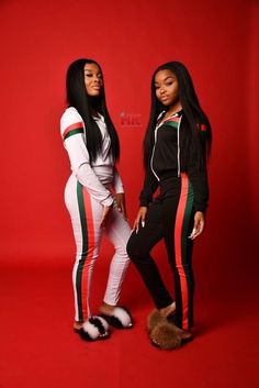 two beautiful women standing next to each other in matching tracksuits, one wearing black and the other white