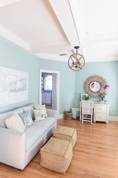 a living room with light blue walls and wood floors