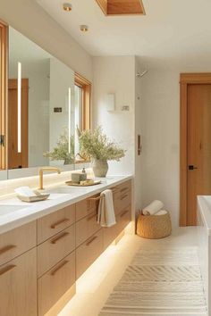 a large bathroom with two sinks and wooden cabinets in the corner, along with a white rug on the floor