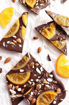 several pieces of chocolate with nuts and orange slices