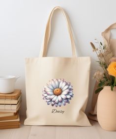 Enjoy this beautiful canvas tote bag with Daisy flower. This trendy and aesthetic tote bag is perfect for running errands, grocery shopping or Farmers Market.  The bag features 20" handles (made from the same canvas),  A great gift idea.  Created with AI. .: 100% cotton canvas .:  One size - 15" x 16" .: Available in natural color .: Perfect for everyday wear .: Heavy & durable fabric (12 oz/yd² (406.9 g/m .: Sewn-in label .: Returns:  All items are made-to-order. Because of the nature of these Beige Flower-shaped Canvas Bag For Daily Use, April Birth Flower, Floral Bags, Book Bag, Birth Flower, Birth Flowers, Grocery Shopping, Shopping Tote, Canvas Tote Bag