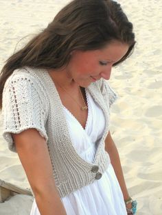 a woman in a white dress on the beach