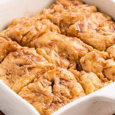 a casserole dish with cinnamon rolls in it