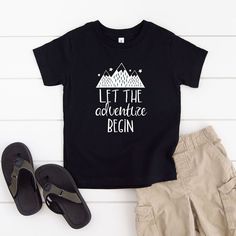 Looking for a cute tee for your kids? We have the perfect Let The Adventure Begin Mountains graphic tee addition to their closet! Also available in toddler tees. Black Graphic Print T-shirt For Adventure, Black Graphic Tee For Adventure, Black Cotton T-shirt For Adventure, Cute Black T-shirt With Funny Text, Mountains Graphic, Mountain Graphic Tee, Let The Adventure Begin, Retro Shorts, Kids Clothes Boys