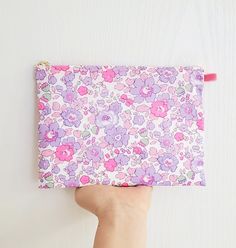 "100% Cotton. Lightweight. From the world famous Liberty Fabrics with a silk-like touch, unique print quality and striking color vibrancy. Exclusive print. Printed in Japan This mini pouch is great size for a couple of small items. Size  Small : 5\"W / 3.25\"H Medium : 5.5\"W / 4.25\"H Large : 9.7\"W / 8\"H Fabric is Liberty of London Tana Lawn. The pouch opens with golden color zipper.(High quality YKK zipper) It comes with a velvet ribbon on one side. Lined inside with pretty baby-pink color cotton. Please, Hand wash. Or cool brilliantly on a machine hand wash. All my works are carefully handmade, hand stitched in a beautiful cotton fabrics. Please give me 1 to 2 days for processing time prior to shipping. Made in a pet and smoke free environment.  Thanks for looking!" Purple Zipper Pouch Cosmetic Bag For Personal Use, Trendy Purple Zipper Pouch, Feminine Cosmetic Pouch For Daily Use, Pink Floral Print Pouch Bag, Feminine Zipper Pouch Cosmetic Bag For Daily Use, Feminine Zipper Pouch, Trendy Purple Zipper Pouch Cosmetic Bag, Cute Multicolor Cosmetic Bag With Zipper Pouch, Feminine Pink Pouch For Gift