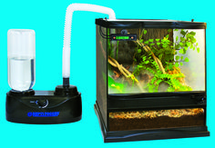 a fish tank with an aquarium inside and a water hose attached to the tank next to it