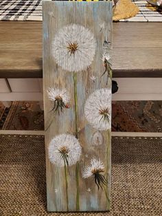 a wooden block with white flowers painted on it