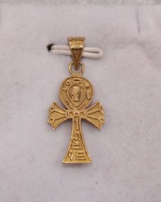 "Egyptian Handmade Ankh Cross Key of Life + Nefertiti 18K Yellow Gold Pendant 1.7Gr Weight Approximate :1.7 Gr Height : 1.1\" = 31 mm Width : 0.5\" = 13 mm ✔ IT IS Tested & SIGNED WITH THE EGYPTIAN Gold Government HALLMARK FOR 18K GOLD to Ensure Authenticity. ✔ Lovely gift idea ABSOLUTELY GORGEOUS, LOOKS FABULOUS ON. ✔ 100% Egyptian handmade. ✔ Condition: A brand-new, exactly as on the photos. ★ GIFTS ✔ All items are packaged in a paper jewelry gift box, ready for gifting. ✔ If you are sendi Gold Symbolic Crucifix Jewelry And Charms, Antique Ankh Jewelry As Gift, Antique Gold Ankh Jewelry, Antique Ankh Jewelry Gift, Antique Ankh Shaped Jewelry Gift, Egyptian Revival Jewelry, Paper Jewelry, Yellow Gold Pendants, Jewelry Gift Box