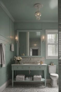 a bathroom with a sink, mirror and toilet in it's centerpieces