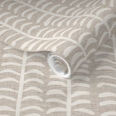 an image of a beige and white wallpaper with wavy lines on the fabric background