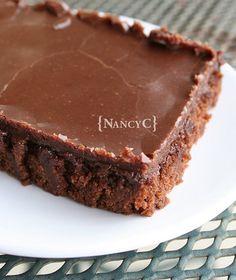 a piece of chocolate cake sitting on top of a white plate