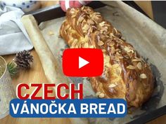 a loaf of bread sitting on top of a wooden cutting board next to pine cones