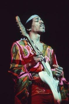 a man playing an electric guitar on stage