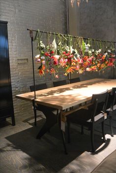 a wooden table with flowers hanging from it