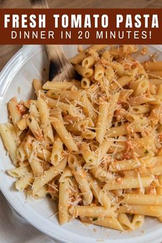 a white plate topped with pasta covered in cheese