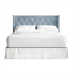 a bed with a blue headboard and white sheets on top of it, in front of a white background