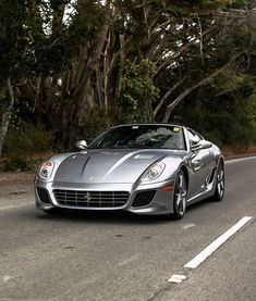 a silver sports car driving down the road