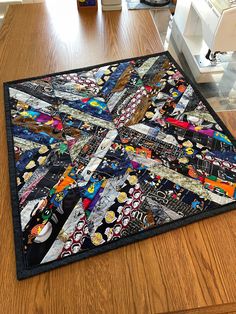 a patchwork quilt on the floor in front of a sewing machine