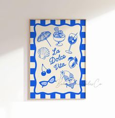 a blue and white framed sign that says la dolce vita with various items on it