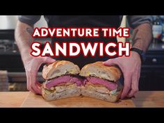 a man holding a sandwich in his hands with the words adventure time sandwich on it