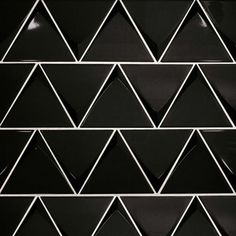 black and white geometric tile with silver lines on the bottom, diagonal triangles at each end